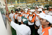 Listening attentively to an explaination on the painting process in Honda's manufacturing plant.